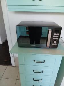 a microwave sitting on top of a counter at Jacqui's abode in Kirstenhof