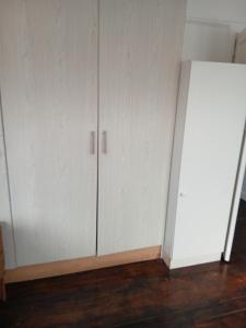 a room with white cabinets and a white refrigerator at Jacqui's abode in Kirstenhof +5 photos