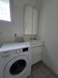 a white washing machine in a kitchen with a sink at Mazet sous les chênes in Valaurie +7 photos