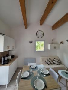 a kitchen and dining room with a table and chairs at Mazet sous les chênes in Valaurie
