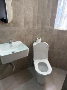 a bathroom with a toilet and a sink at Highveld Nook in Sasolburg +12 photos