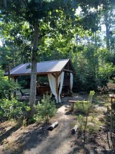 a gazebo in the middle of a forest at Wood Camping in Brochów