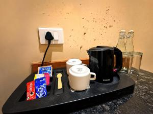 a counter top with a coffee maker and a coffee pot at HOTEL in PURI - SWIMMING POOL RB - Near Sea Beach & Shree Jagannath Temple - wifi - Parking - Restaurant - in Puri