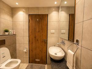 a bathroom with a toilet and a sink at HOTEL in PURI - SWIMMING POOL RB - Near Sea Beach & Shree Jagannath Temple - wifi - Parking - Restaurant - in Puri +15 photos