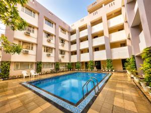 a swimming pool in front of a building at HOTEL in PURI - SWIMMING POOL RB - Near Sea Beach & Shree Jagannath Temple - wifi - Parking - Restaurant - in Puri