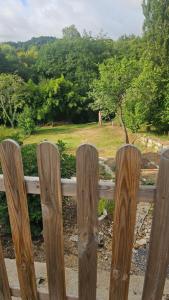 a wooden fence with a view of a field at Au bord de La Boëme in Mouthiers-sur-Boëme +3 photos