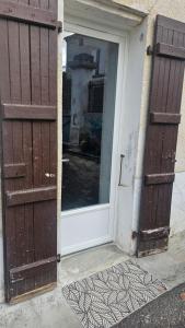 an open door of a house with a window at Au bord de La Boëme in Mouthiers-sur-Boëme