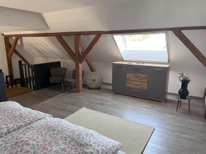a bedroom with a bed and a sink and a window at Ferienwohnung Sabrina in Aichen
