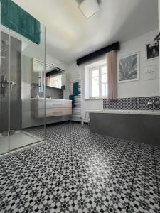 a bathroom with a shower and a tiled floor at Ferienwohnung Sabrina in Aichen +20 photos