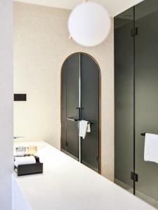 a mirror in a bathroom with a white counter at Aomori Hotel -Foshan Shunde Qinghui Garden Resort OCT Harbour PLUS Branch in Shunde +57 photos
