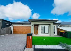 a house with a green lawn in front of it at Grand Suite with Ensuite Bathroom in Wyndham Vale