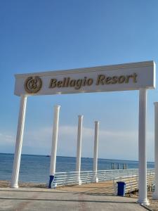 a sign that says beluga resort on the beach at Issyk-Kul in Balykchy