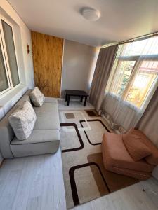 a living room with a couch and a table at Issyk-Kul in Balykchy