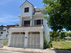 a white house with a white gate at BTLk D16- 27-02 in Thủy Triều