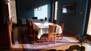 a dining room with a white table and chairs at Gospodarstwo Agroturystyczne-Pensjonat SAD in Podgórzyn
