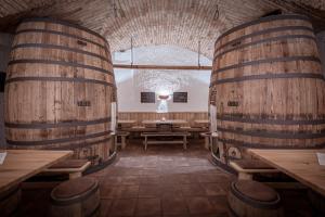 a room with two wine barrels and wooden tables at Hotel Plankenhof B&B in Pill