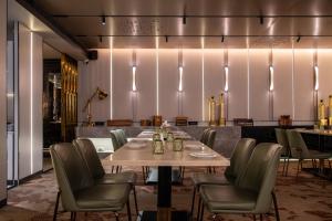 a dining room with a table and chairs at 10 Park Street Hotel & Banquets in Gorakhpur +41 photos
