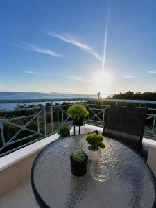 a table with potted plants on top of a balcony at Velmare apartments in Paralia Vrachou +2 photos