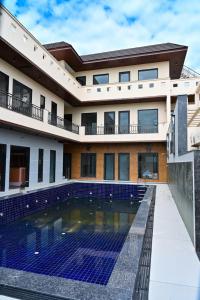 a house with a swimming pool in front of it at Sukuun Villa Airport Road #Luxury Pool Stay in Sri Guru Ram Dass Jee International Airport