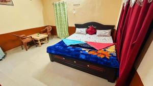 a small bedroom with a bed with a canopy at Siddhartha homevibes hampi in Hampi