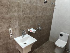 a bathroom with a sink and a toilet at Diksha Heritage In in Prayagraj