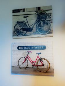 two pictures of a bike on a wall at Przytulna Kawalerka w Kamienicy in Olsztyn