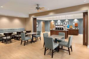 a restaurant with tables and chairs and a bar at Hampton Inn Bartow in Bartow