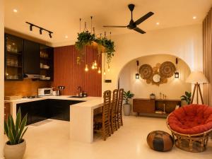 a kitchen with a table and chairs and a ceiling at The Neylipz - Fully Air Conditioned 3 bedroom Apartment in Weligama