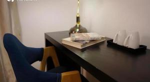 a desk with a chair and a lamp and books at Dali Five Elements Hostel in Dali Ancient Town