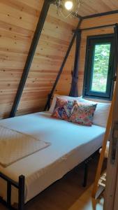 a bedroom in a log cabin with a bed at La Vica Bungalow in Rize