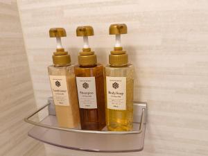 three bottles of essential oils in a metal shelf at le Lac Hotel Yokkaichi in Yokkaichi +12 photos