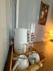 a table with a blender and two tea pots at TAGBALAYON-GARDEN Guest House in Siquijor