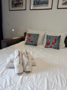 a white bed with towels and pillows on it at Palace Riviera Studio - Plages & Centre Menton in Menton