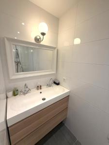 a white bathroom with a sink and a mirror at Palace Riviera Studio - Plages & Centre Menton in Menton +21 photos