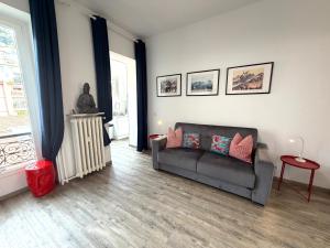a living room with a couch and a window at Palace Riviera Studio - Plages & Centre Menton in Menton