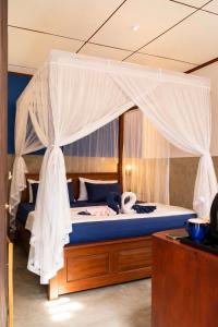 a bedroom with a bed with a canopy at 87 Ahangama in Ahangama +1 photo