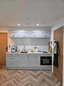 a kitchen with a sink and a stove top oven at Rock Mill Retreat in Stony Middleton +58 photos