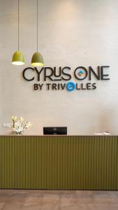 a sign for a cyprus one by tryules on a wall at Cyrus One By Trivelles in Islamabad