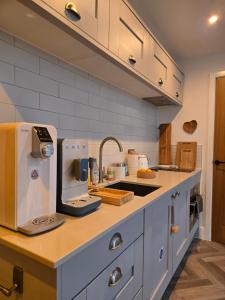 a kitchen with a counter with a kitchen appliance at Rock Mill Retreat in Stony Middleton