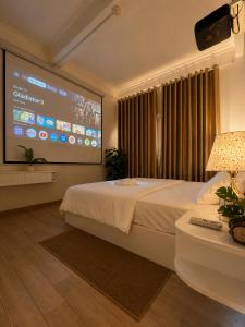 a hotel room with a bed and a large screen at Moonland Hotel in Phương Lăng
