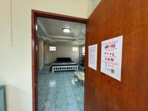a door leading to a living room with a couch at Tommy Apartment - main road in Ko Tao