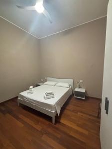 a bedroom with a bed and a ceiling fan at Villa Olivieri 1928 in Ascoli Piceno