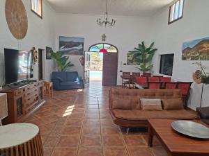a living room with a couch and a table at Casa Palmeral in Mácher