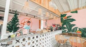 a person standing behind a counter in a restaurant at The State Resort in Ban Wat Phrik (1)