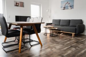 a living room with a table and a couch at Fewo 14 DG in Goch
