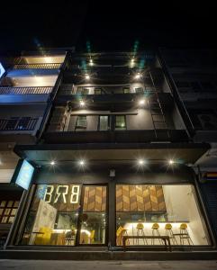 a building with a store front at night at BRB Hostel Bangkok Silom in Bangkok