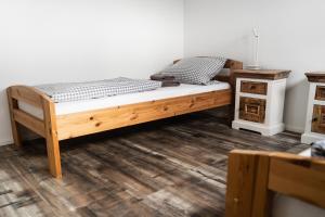 a wooden bed in a room with a wooden floor at Fewo 14 DG in Goch