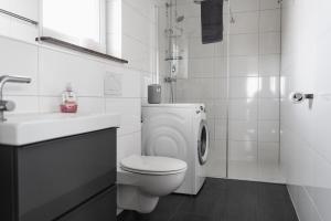 a white bathroom with a toilet and a sink at Fewo 14 DG in Goch