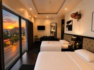 a hotel room with two beds and a large window at Moonland Hotel in Phương Lăng