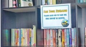 a book shelf filled with lots of books at Mayon Backpackers Hostel in Legazpi